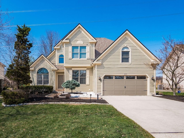 traditional-style house featuring a garage, concrete driveway, and a front yard