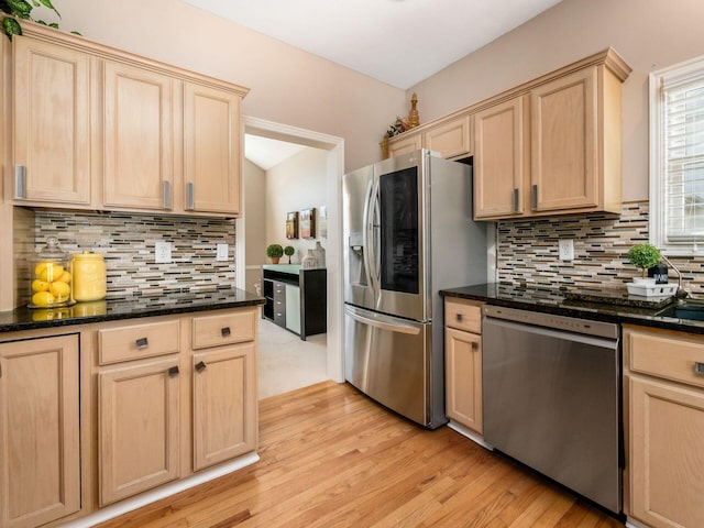 kitchen with decorative backsplash, light wood-style flooring, light brown cabinets, and stainless steel appliances