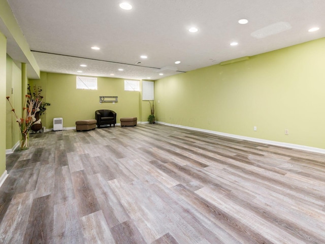 unfurnished room featuring recessed lighting, wood finished floors, and baseboards