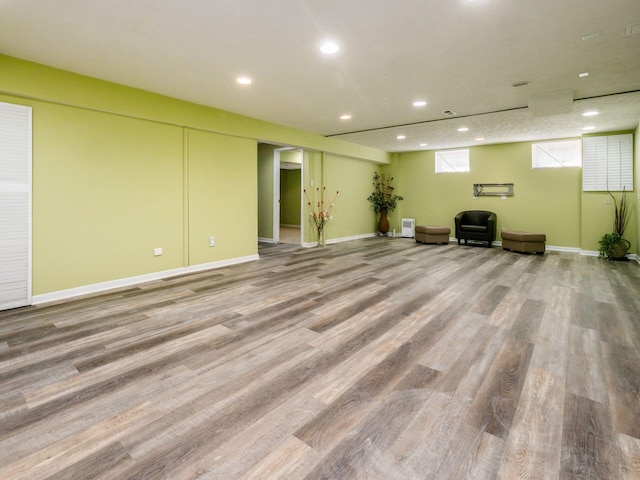 basement featuring recessed lighting, wood finished floors, and baseboards