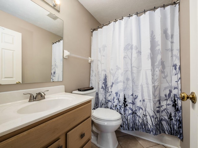 bathroom with tile patterned flooring, toilet, a shower with shower curtain, vanity, and a textured ceiling