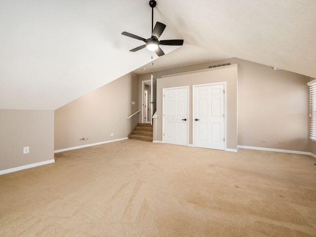 bonus room with visible vents, baseboards, ceiling fan, light colored carpet, and lofted ceiling