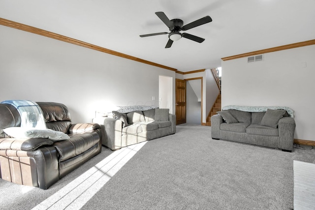 living room featuring stairway, a ceiling fan, visible vents, carpet floors, and crown molding