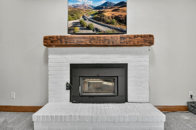 details with a brick fireplace, baseboards, and carpet floors