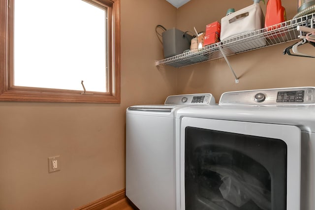 clothes washing area with washing machine and clothes dryer and laundry area