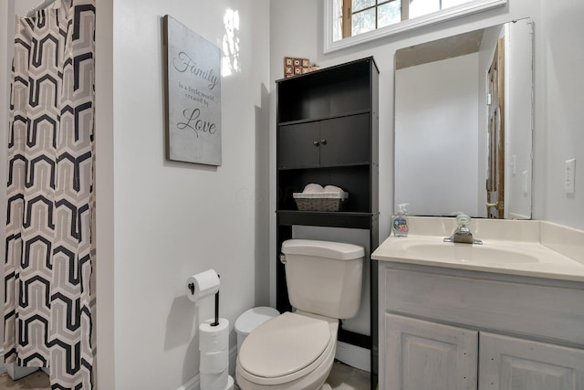 bathroom with vanity, toilet, and a shower with curtain