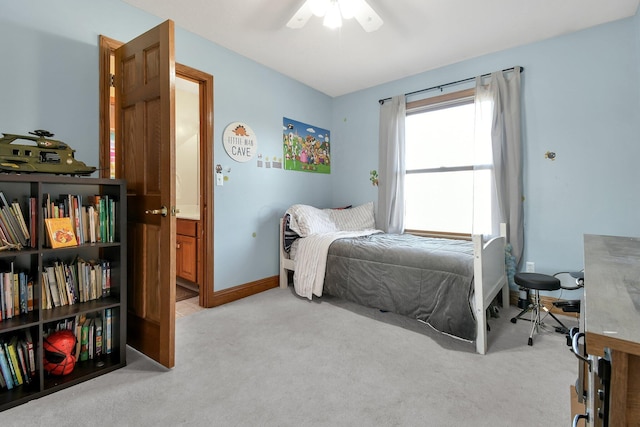 bedroom with a ceiling fan, baseboards, and light carpet