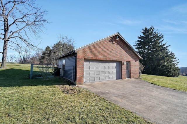 view of side of home with an outbuilding, a yard, brick siding, and a garage