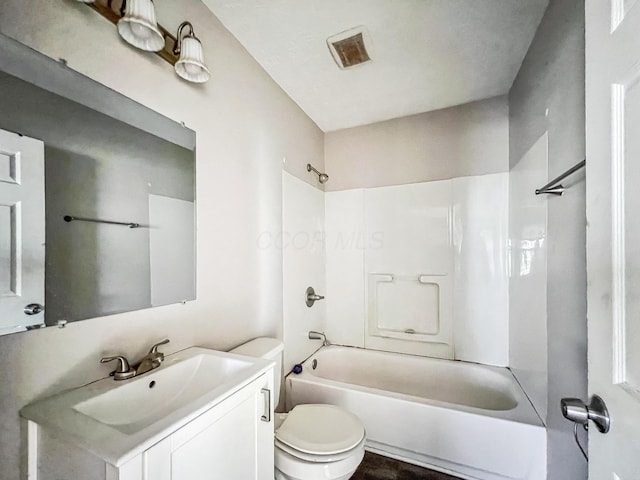 bathroom with bathtub / shower combination, toilet, vanity, and visible vents