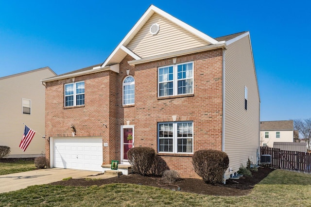 traditional-style home with brick siding, an attached garage, concrete driveway, and fence