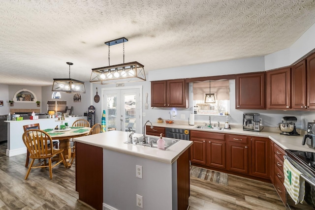 kitchen featuring a sink, black / electric stove, wood finished floors, and light countertops