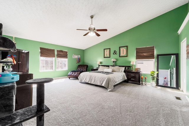 carpeted bedroom featuring visible vents, baseboards, ceiling fan, vaulted ceiling, and a textured ceiling