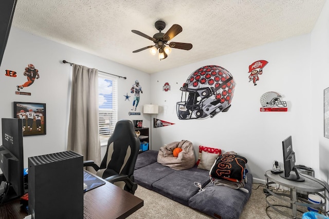 home office with carpet floors, a textured ceiling, and a ceiling fan