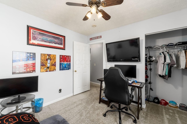 office with baseboards, carpet, a ceiling fan, and a textured ceiling