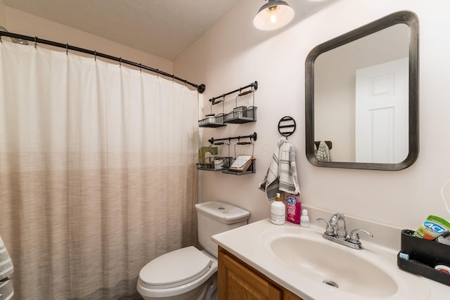 bathroom featuring curtained shower, a textured ceiling, toilet, and vanity