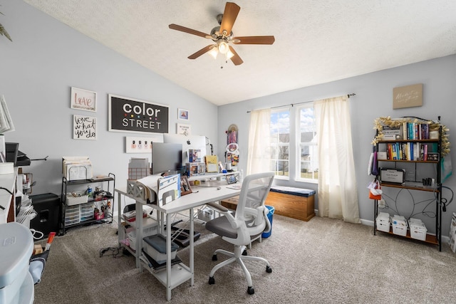 carpeted office space featuring baseboards, lofted ceiling, a textured ceiling, and a ceiling fan