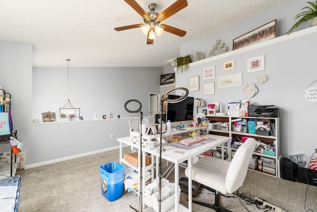 home office featuring carpet flooring, ceiling fan with notable chandelier, baseboards, and a textured ceiling