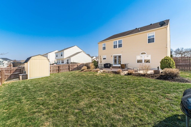 back of property with a patio, a yard, a fenced backyard, and an outdoor structure