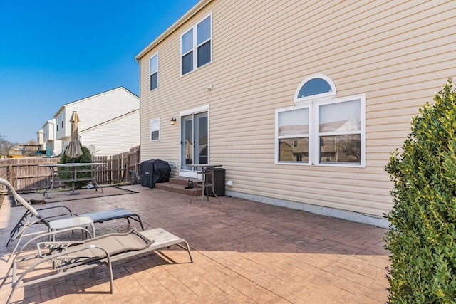 view of patio / terrace featuring area for grilling, outdoor dining space, and fence