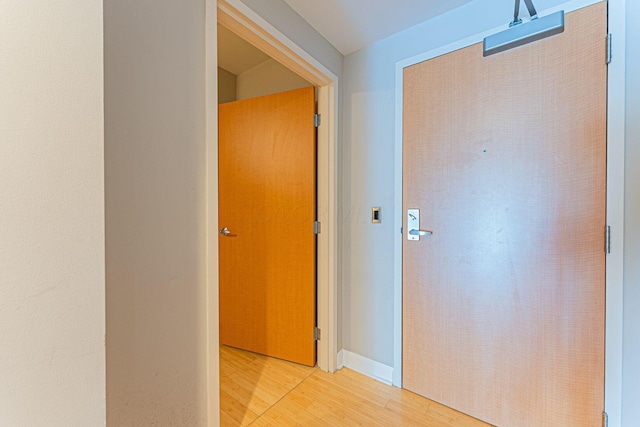 corridor with light wood-style floors