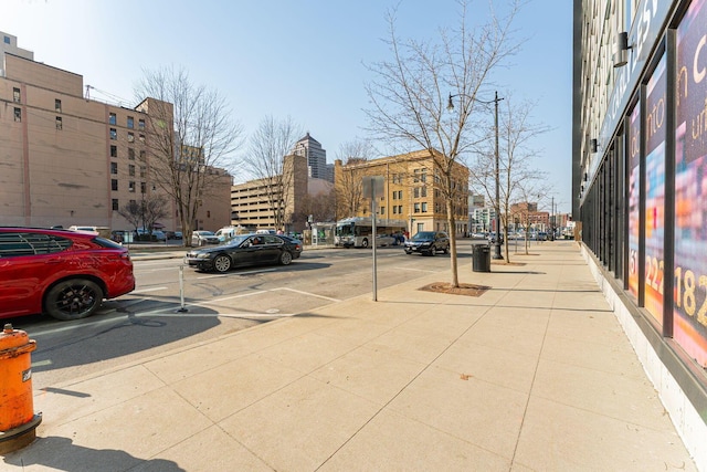 view of road featuring street lights and sidewalks