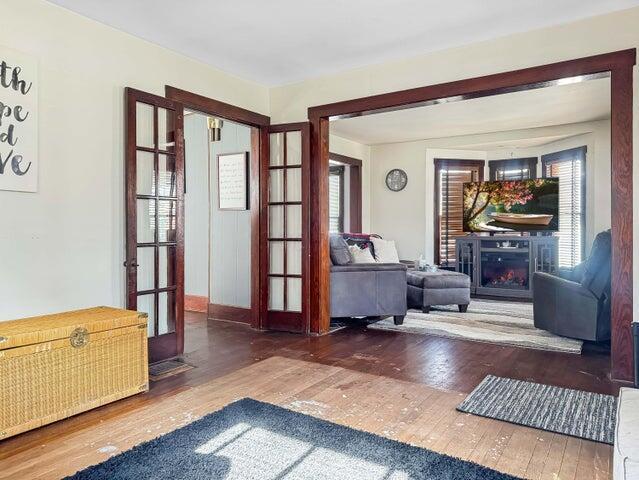 812 S Main St, Urbana, OH 43078 - interior space with a warm lit fireplace, french doors, and hardwood / wood-style flooring