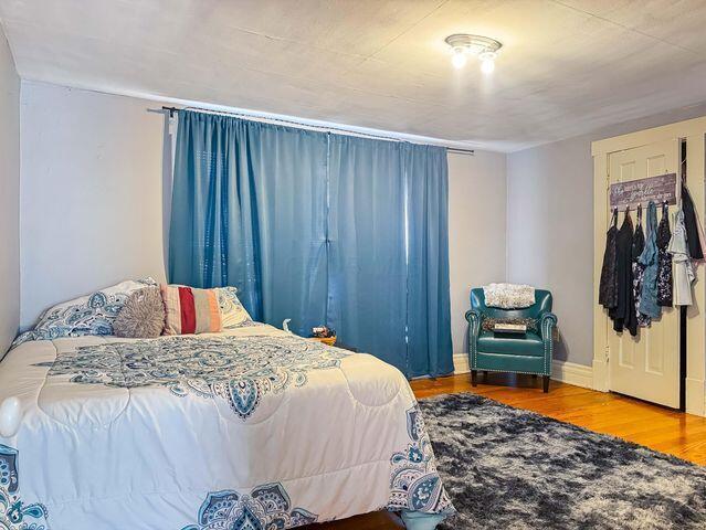 812 S Main St, Urbana, OH 43078 - bedroom with baseboards and wood finished floors
