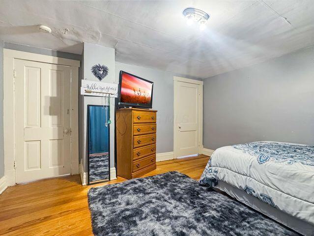 812 S Main St, Urbana, OH 43078 - bedroom featuring baseboards and light wood-type flooring