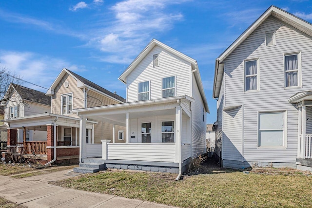 traditional-style home with a front yard and covered porch