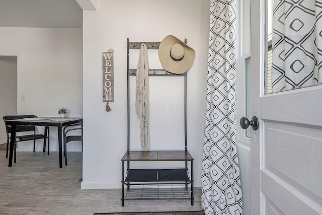 interior space featuring baseboards and wood finished floors