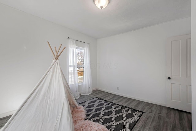 unfurnished bedroom featuring baseboards and wood finished floors