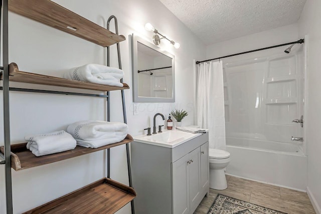 bathroom with wood finish floors, toilet, vanity, shower / bath combination with curtain, and a textured ceiling