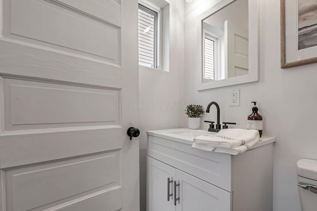 bathroom with vanity and toilet