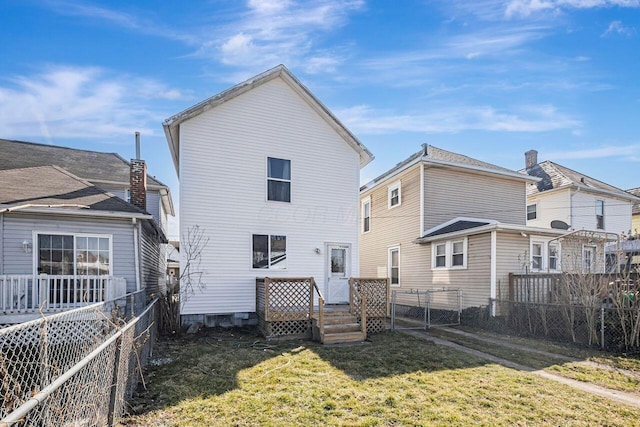 back of house featuring a gate, a yard, and fence