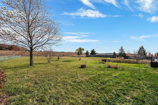 view of yard with a rural view and fence