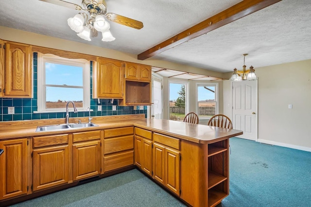 kitchen with open shelves, a peninsula, a sink, decorative backsplash, and beamed ceiling