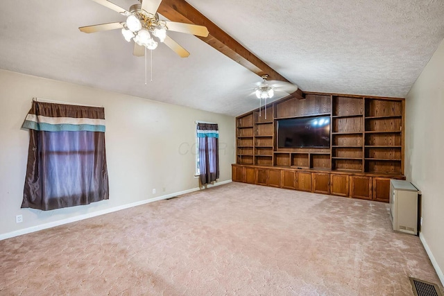unfurnished living room featuring visible vents, a textured ceiling, carpet flooring, ceiling fan, and vaulted ceiling with beams