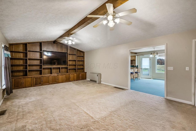 unfurnished living room featuring lofted ceiling with beams, baseboards, a textured ceiling, and carpet flooring