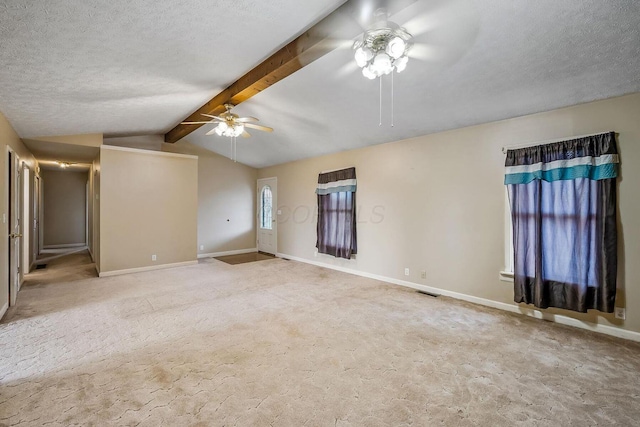 spare room with vaulted ceiling with beams, baseboards, ceiling fan, carpet flooring, and a textured ceiling