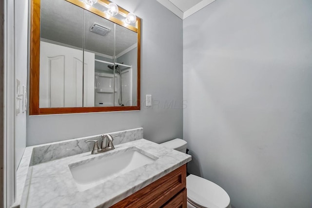 bathroom with an enclosed shower, visible vents, toilet, crown molding, and vanity