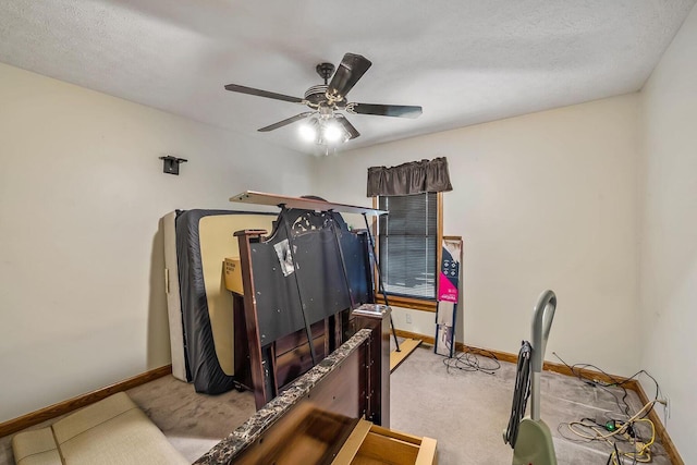 bedroom featuring a textured ceiling, a ceiling fan, baseboards, and carpet floors