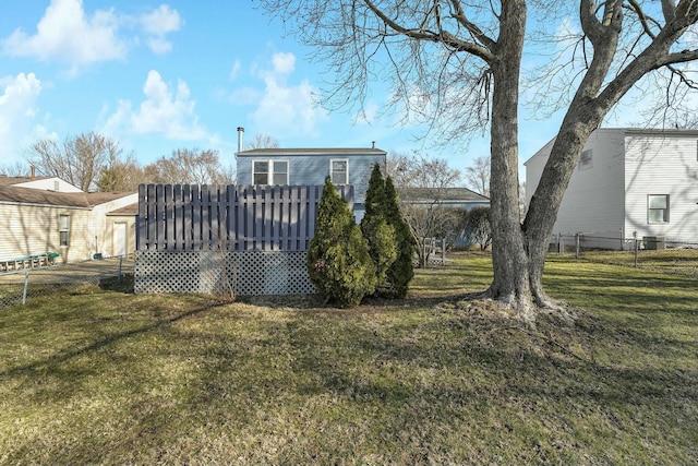 back of house with a yard and fence