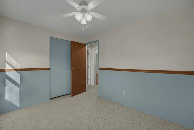 unfurnished room with ceiling fan and carpet floors