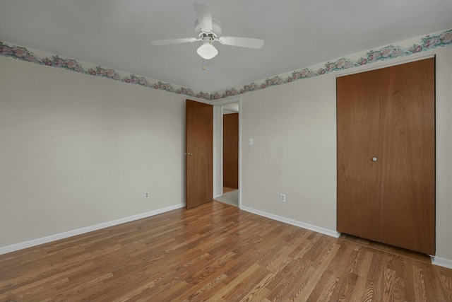 unfurnished bedroom with light wood-type flooring, baseboards, and ceiling fan