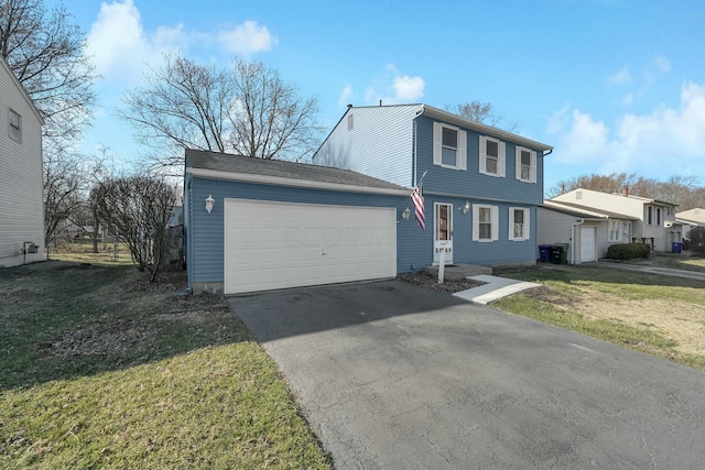 colonial-style house with a garage, a front lawn, and aphalt driveway