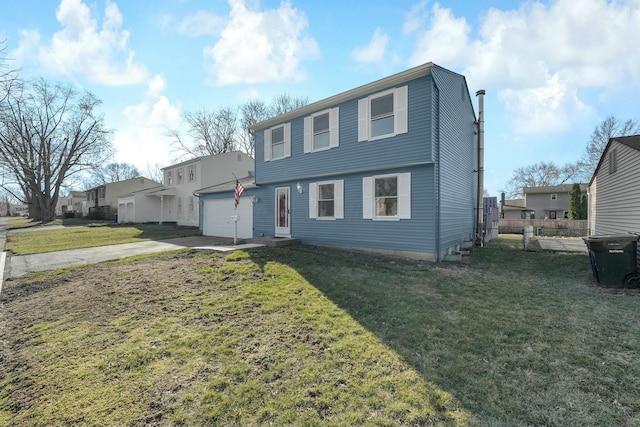 colonial-style house featuring concrete driveway, a front yard, and fence