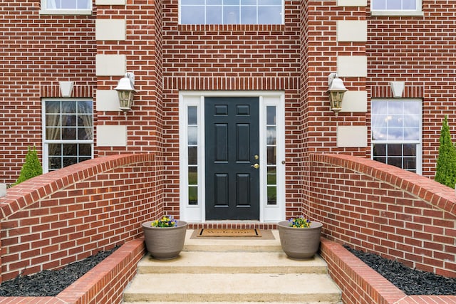 property entrance with brick siding