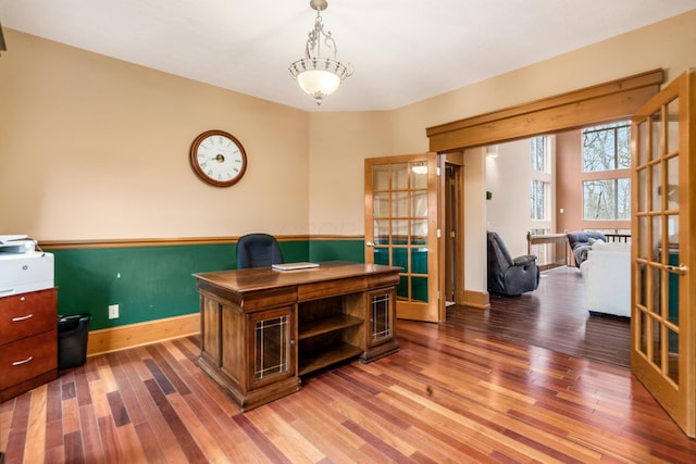 home office with french doors, baseboards, and wood finished floors