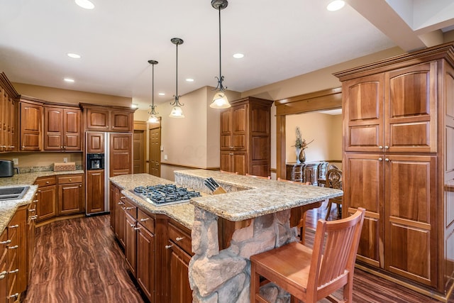 kitchen featuring recessed lighting, paneled built in fridge, a kitchen island, and dark wood-style floors