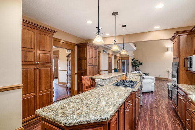 kitchen featuring dark wood finished floors, open floor plan, appliances with stainless steel finishes, and a kitchen island
